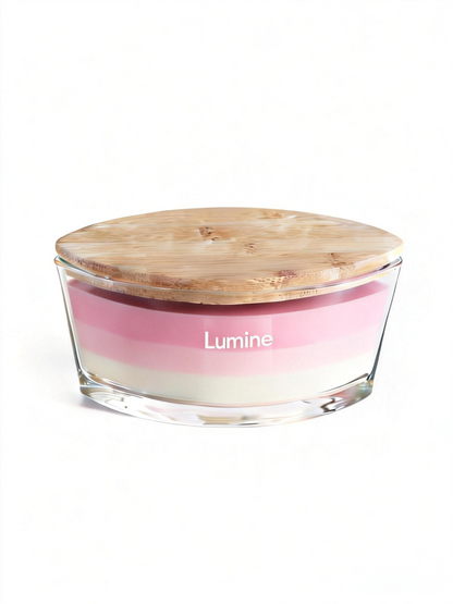 Front view of Lumine Gardenia & Jasmine soy wax candle in a glass jar with a wooden lid on a white background.