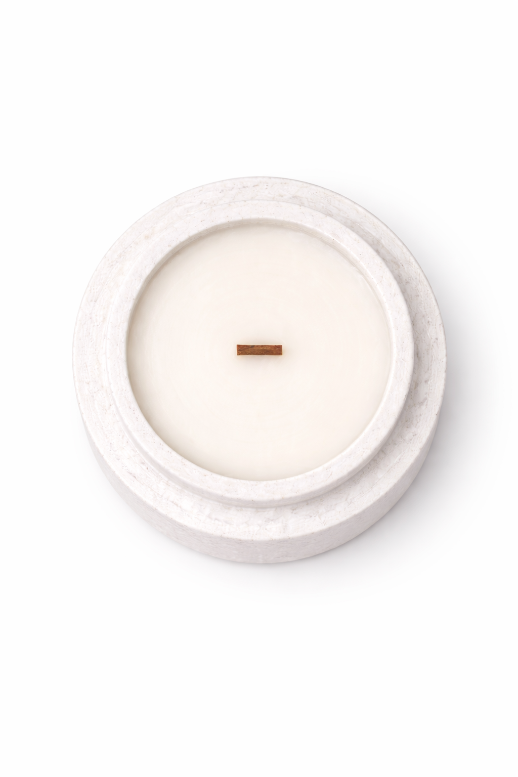 Top-down view of Lumine Ginger & Grapefruit soy wax candle in a stone-style vessel, showing the wax surface and wick.