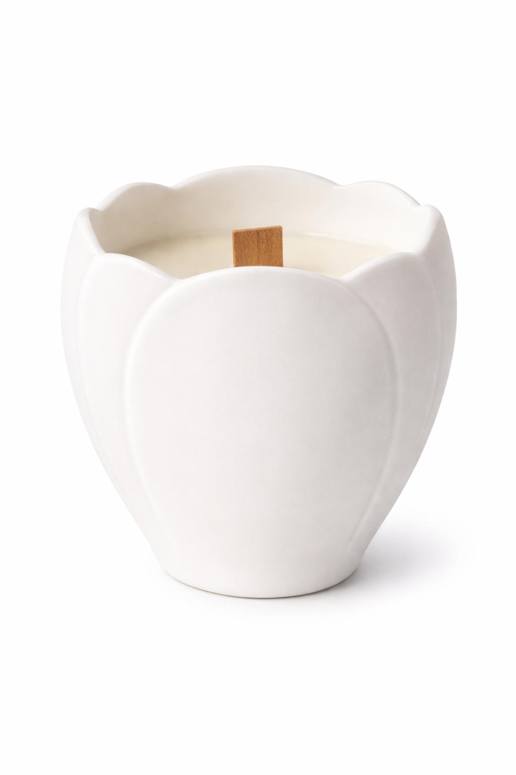 Front view of Lumine Vanilla & Amber soy wax candle in a magnolia-shaped porcelain vessel with a wooden wick on a white background.